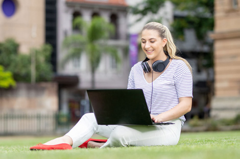 Student studying outside on laptop