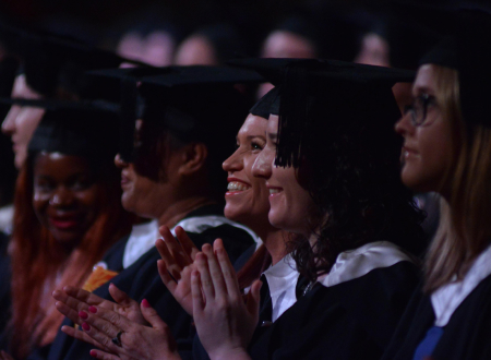 Graduates smiling and clapping