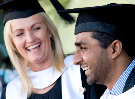 Two graduates smiling