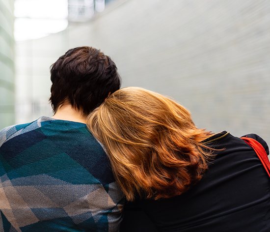 A woman resting her head on a man