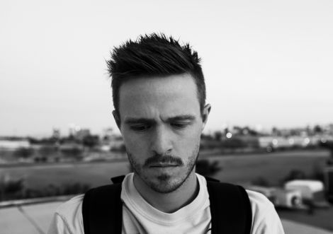 Black and white headshot of an individual wearing a backpack